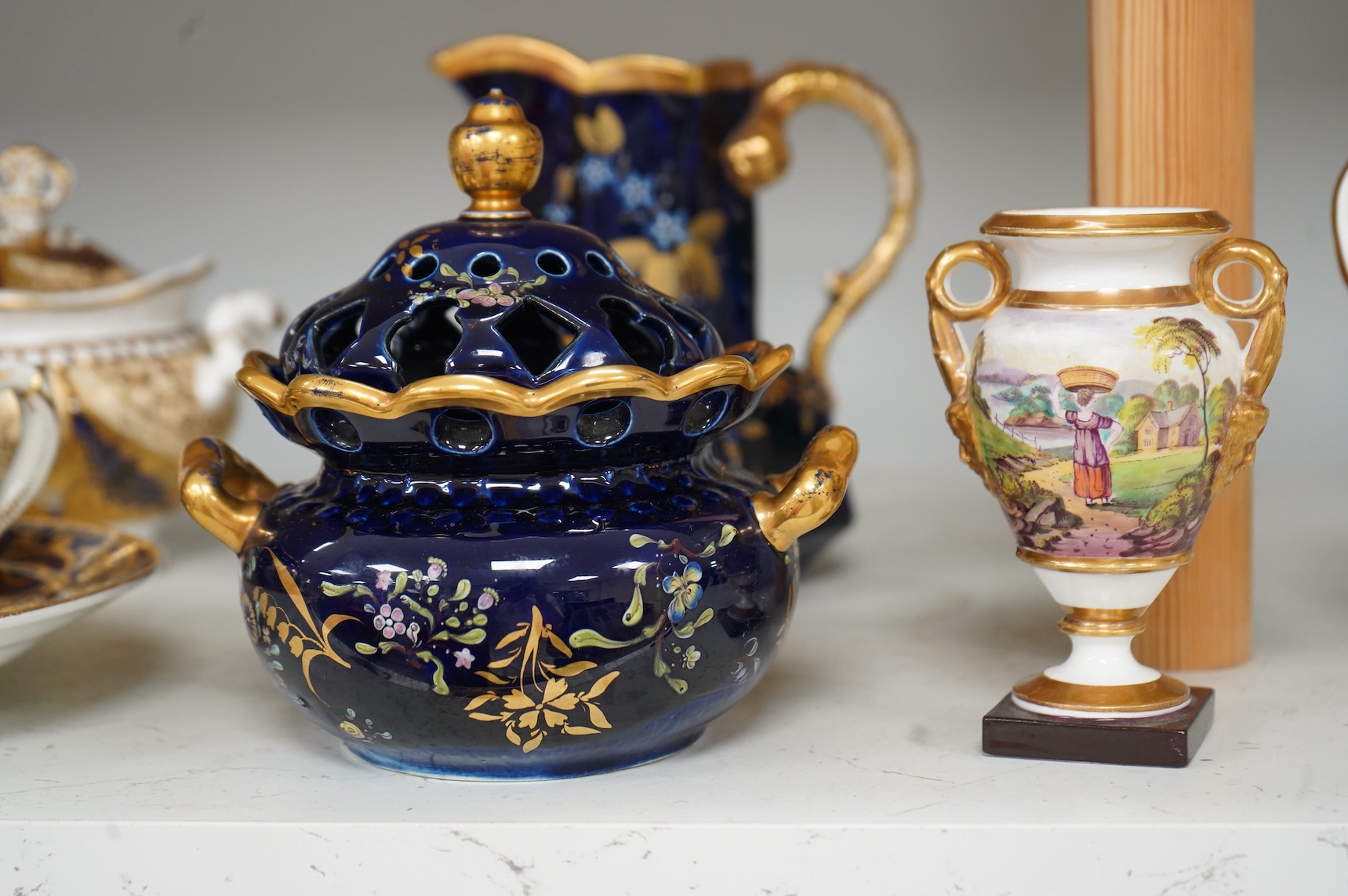 A Group of early 19th century English porcelain; to sauce tureens and covers, one with stand, a covered sugar bowl, a two handled vase, a pot pourri vase and cover, a milk jug and a hydra shaped jug, largest 16cm high